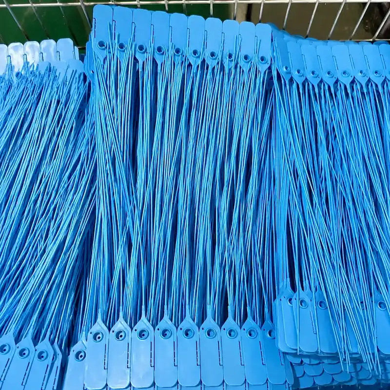 Blue plastic indicative seals in bulk production for tamper-evident cargo security and logistics applications